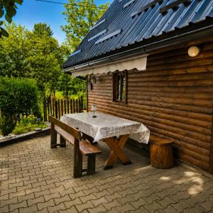 a table and a bench in front of a building at Country house in nature -10 min from Nikola Tesla Memorial Center-peace and privacy in Klanac