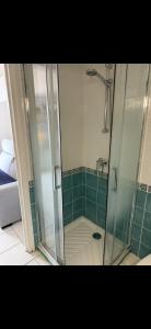 a shower with a glass door in a bathroom at Studio with sea and mountain view in Sainte-Agnès
