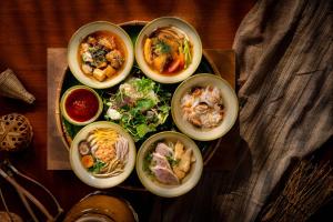 a plate of different types of food on a table at Renaissance Riverside Hotel Saigon in Ho Chi Minh City +94 photos