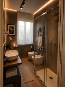 a bathroom with two sinks and a glass shower at The Captain's Apartments Marina - next to Verbella - Leonardo Academy, MXP in Sesto Calende