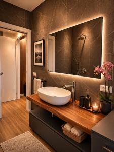 a bathroom with a sink and a large mirror at The Captain's Apartments Marina - next to Verbella - Leonardo Academy, MXP in Sesto Calende