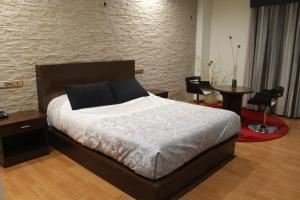 Postel nebo postele na pokoji v ubytování Hotel El Castillo