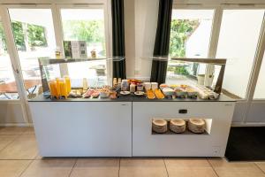 a counter with some food and drinks on it at Kyriad Digne-Les-Bains in Digne-les-Bains