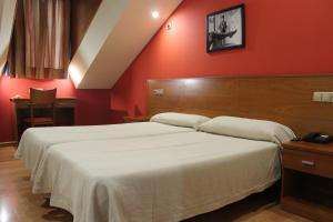 Postel nebo postele na pokoji v ubytování Hotel El Castillo
