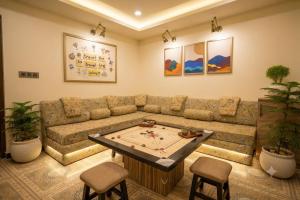 a living room with a couch and a table at 3 Raahi Varanasi in Varanasi