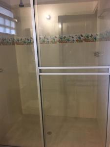 a glass shower stall with a glass door at Casa Campestre Villa Esperanza in Silvania