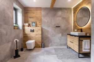 a bathroom with a toilet and a sink and a mirror at Cozy mountain house - Coolówka pod Babią Górą in Zubrzyca Dolna +18 photos