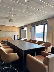 a large conference room with a large table and chairs at Keruen inn Karaganda in Karagandy