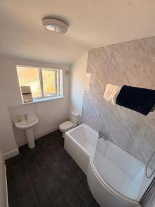 a bathroom with a tub and a toilet and a sink at Alexandra View in Goole