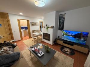 a living room with a large flat screen tv at La Sima del Anillo in Cardaño de Abajo