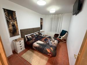 a bedroom with a bed with a deer on it at La Sima del Anillo in Cardaño de Abajo +38 photos