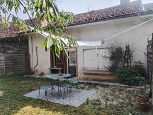 a patio with a table and chairs in front of a house at Le Nichoir de Lesmont in Lesmont