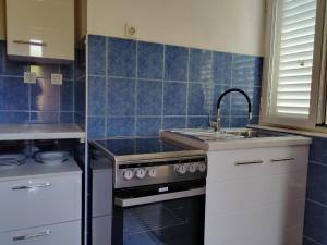 a kitchen with a sink and a stove at inKorcula in Korčula