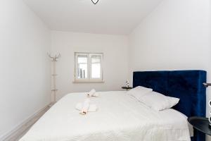 a white bed with two towels on top of it at Villa Sunshine in Pridraga +44 photos
