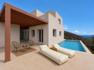 a villa with a swimming pool on a patio at Vespera Private Luxury Suites in Santorini