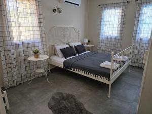 a bedroom with a white bed and two windows at 2-Bedroom Flat with a Private Swimming Pool in Bodrum City +22 photos