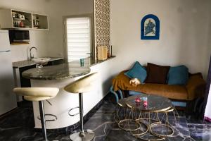 a living room with a couch and two tables at Dar Mimouna Djerba in Tianest