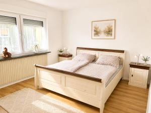 a bedroom with a bed in a white room at Ferienwohnung Birke in Sankt Wendel