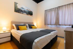 a bedroom with two beds with yellow pillows at Green Cube Capsule Hostel in Sofia