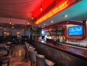 a man standing at a bar in a restaurant at Malmaison Hotel Leeds in Leeds