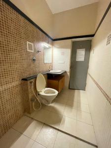 a bathroom with a toilet and a sink at Neha's Homestay in Mysore