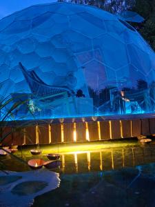 a dome house is lit up at night at Dôme Renard by Out & Lodge in Couvin