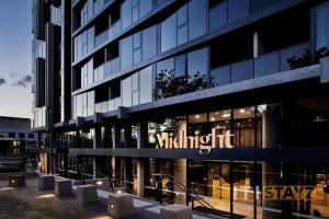 a building with a sign on the side of it at Braddon Base in The Midnight, Heated Pool & Sauna in Braddon