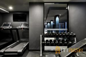 a gym with a view of a city at Braddon Base in The Midnight, Heated Pool & Sauna in Braddon
