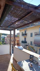 a patio with a table and chairs on a roof at Romantic Studio Apartment Near Park in Rome