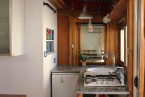 a kitchen with a stove and a sink in a room at Romantic Studio Apartment Near Park in Rome