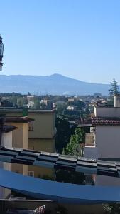 a view of a city with mountains in the background at Romantic Studio Apartment Near Park in Rome +3 photos
