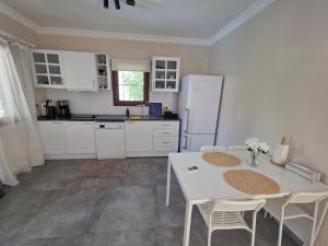 a kitchen with a table and chairs and a refrigerator at 2-Bedroom Flat with a Private Swimming Pool in Bodrum City