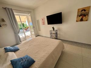a bedroom with a bed and a flat screen tv at To Be Capri Sea view Rooms in Capri +18 photos