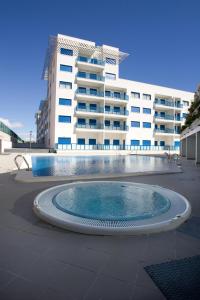a swimming pool in front of a large building at Alicante Hills in Alicante
