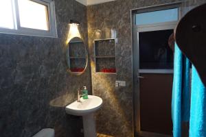 a bathroom with a sink and a mirror at Cocolala Beach House in Nungwi +39 photos