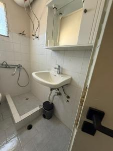 a bathroom with a sink and a shower and a mirror at Antilia corfu 4 in Agios Georgios +18 photos