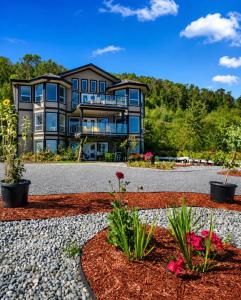 a large house with a gravel driveway at Seaview Executive Home in Ladysmith