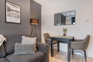a living room with a couch and a table at Southend Cottage By Birch Stays in Penrith
