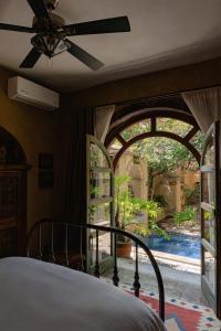 a bedroom with a bed and a view of a pool at Hacienda Las Amantes in San Miguel de Allende