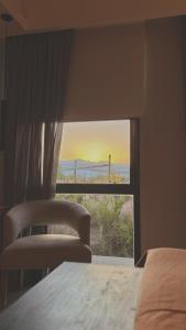 a bedroom with a window with a view of the desert at Amerian Chacras de Coria in Chacras de Coria +31 photos