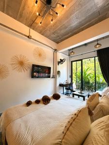a bedroom with a large bed with a large window at Jip Studio - 3mn ZenBeach - Garden View in Haad Chao Phao