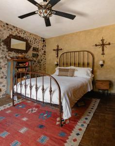 a bedroom with a bed and a ceiling fan at Hacienda Las Amantes in San Miguel de Allende +44 photos