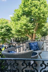a wrought iron fence with two chairs with blue pillows at MSK The Whiteley in London
