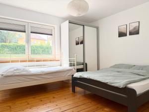 a bedroom with two beds and a window at GM Jagiellończyk in Olsztyn