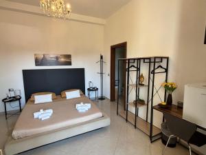 a bedroom with a large bed and a chandelier at B&B IL TULIPANO free private parking in Como +15 photos