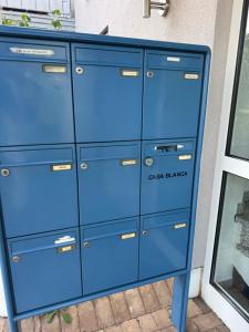 a blue dresser in front of a window at Appartement by Luis in Burgheim