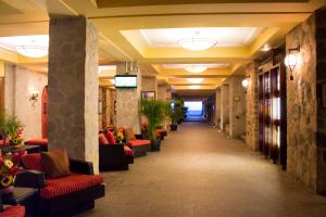 a hallway with couches and chairs in a lobby at Pierre Mundo Imperial Riviera Diamante Acapulco in Acapulco