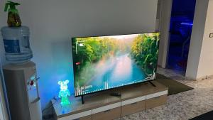 a flat screen tv sitting on a stand in a living room at Villa Pinzon in Moià