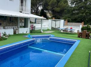 a swimming pool in the backyard of a house at Villa Pinzon in Moià