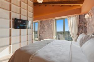 a bedroom with a bed and a tv on a wall at Agroturizem Cialda in Shkallnur +57 photos
